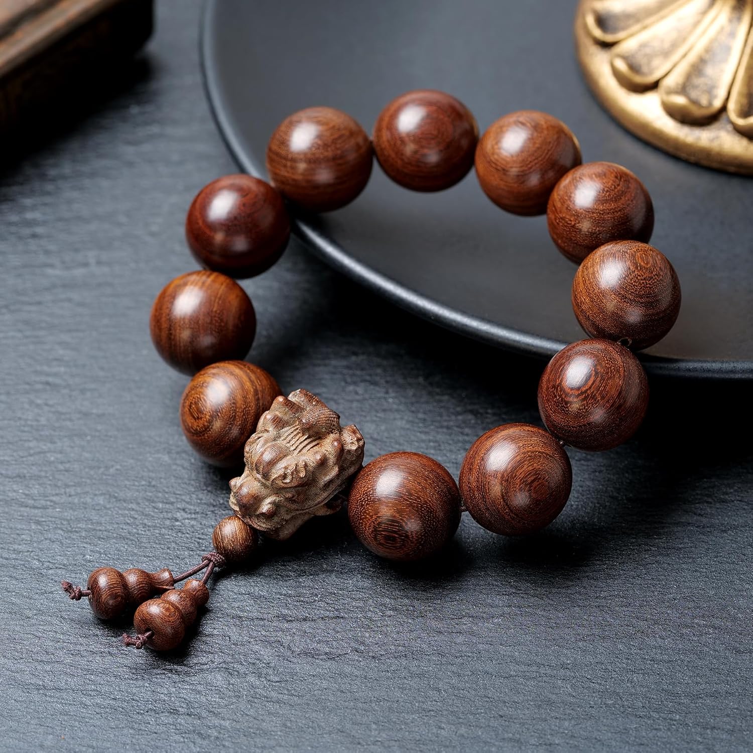 A 20-millimeter-diameter bracelet made of 12 hand-carved wooden beads, adorned with a carved dragon design